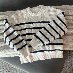 White with blue striped sweater